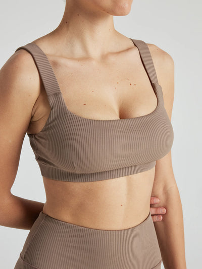 Model wears sustainable square neck light brown nylon rib sports bra