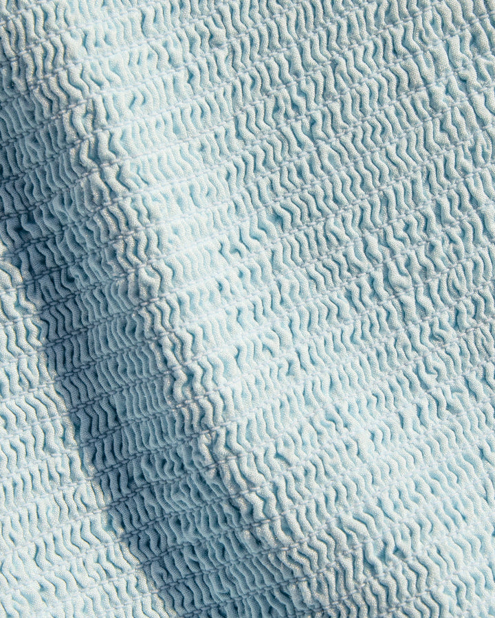 Close-up of the LSPACE Misha Midi in Tourmaline, highlighting the wavy smocked fabric texture in the powder blue Tourmaline color.