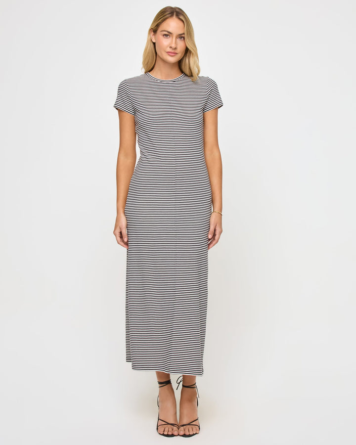 Front view of a model wearing the LSPACE Sloane Dress in black-cream, a fitted maxi dress with black and cream horizontal stripes, a crew neckline, and short cap sleeves.