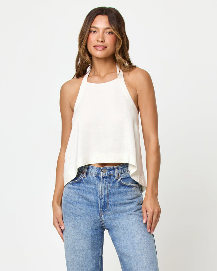 LSPACE Milly top in cream, styled with jeans, front view on model.