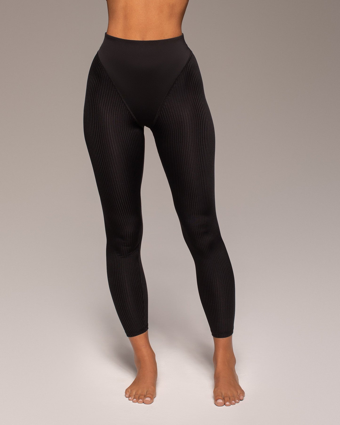 Black leggings worn by a person on a neutral background