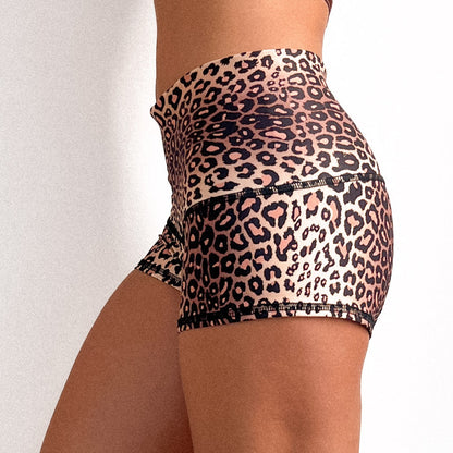 A pair of animal print shorts designed for active wear, showing a side view of the pattern and fit.