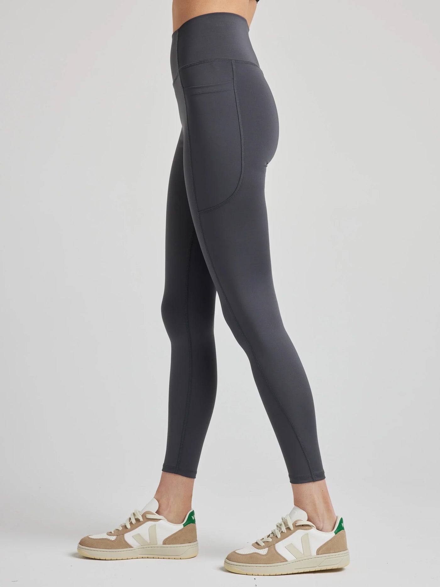 model wears sculpting grey pocket leggings