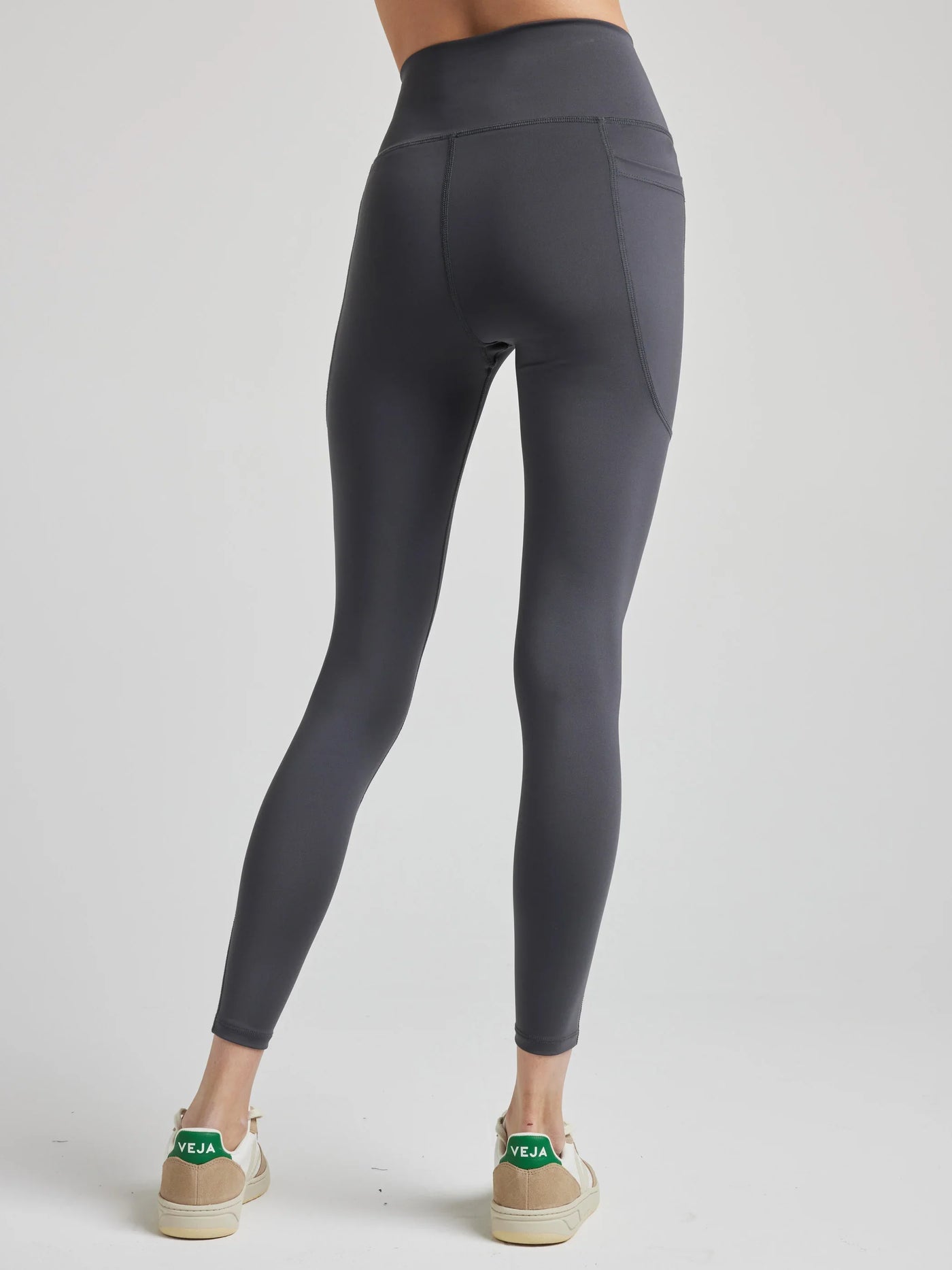 model wears sculpting grey pocket leggings