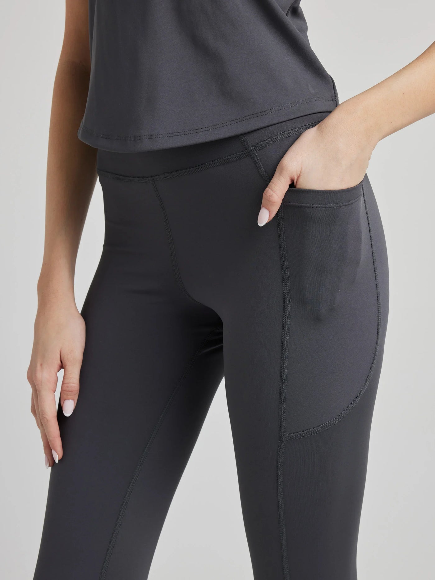 model wears sculpting grey pocket leggings