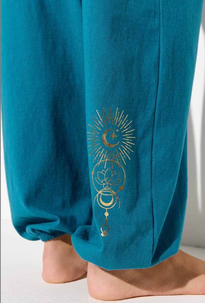 Close-up of Spiritual Gangster logo on Lunar Light Canyon Lightweight Cotton Sweatpants in Blue Lagoon