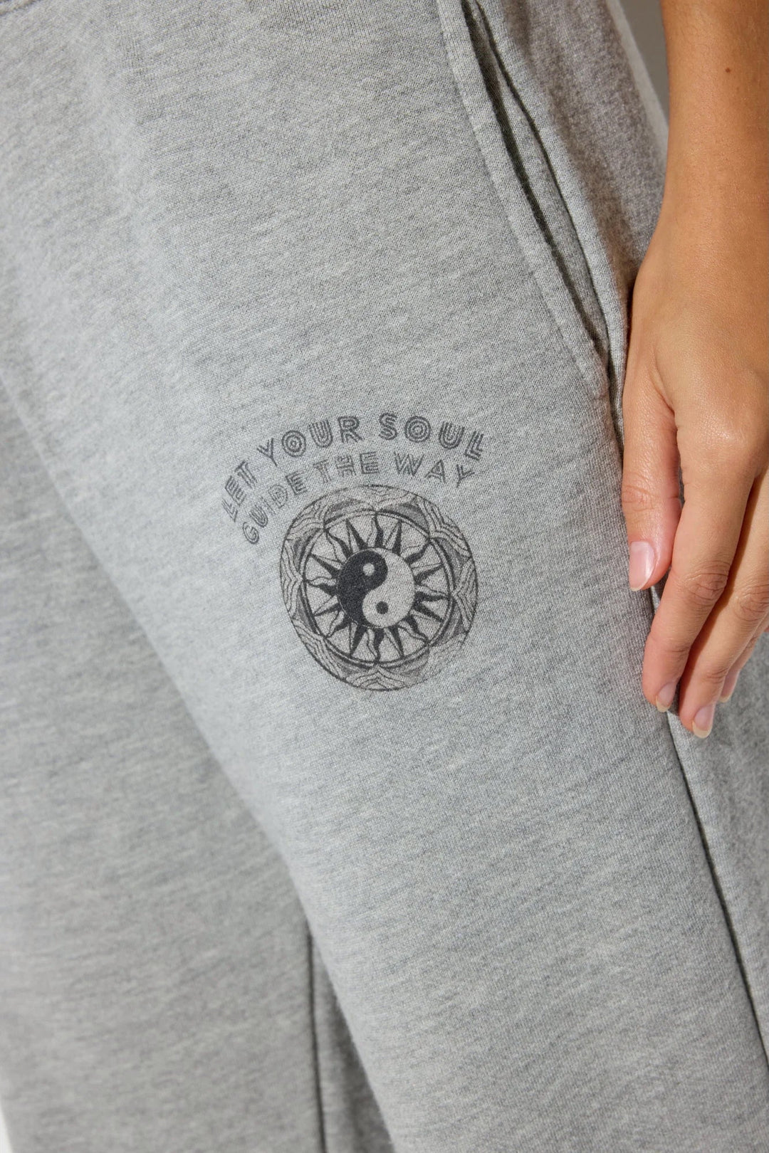 Close-up of the Spiritual Gangster logo on Soul Guide Eden Cotton Blend Sweatpants in Light Heather Grey