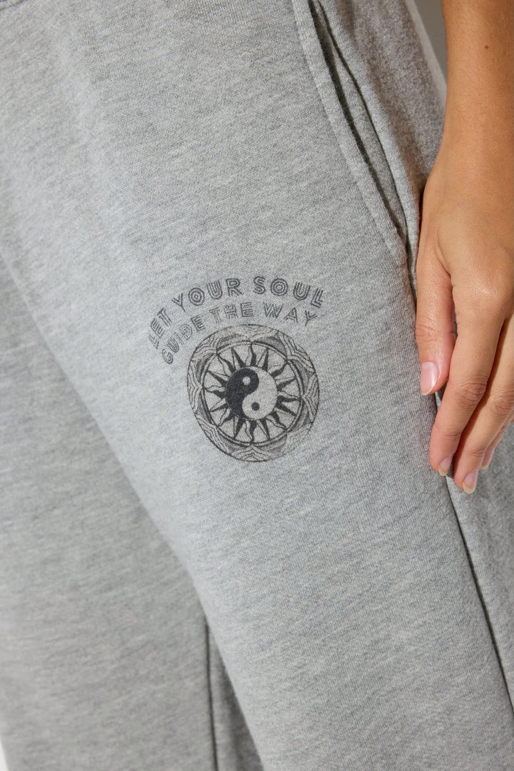 Close-up of the Spiritual Gangster logo on Soul Guide Eden Cotton Blend Sweatpants in Light Heather Grey