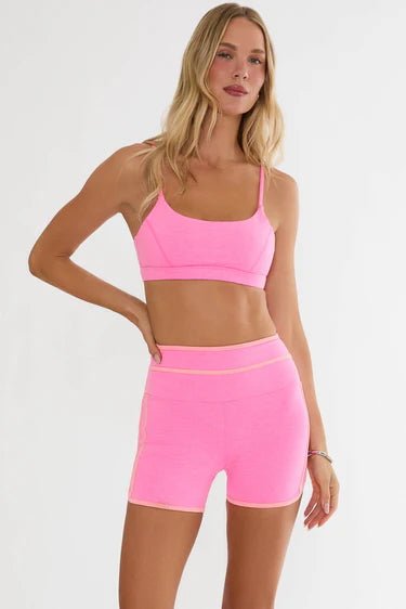 Beach Riot Sara Top Sports Bra in Shoreline Pink styled with matching shorts